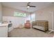 Bedroom with crib, accent wall, chair and natural light at 2256 Pantucket Dr, Wesley Chapel, FL 33543