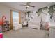 bedroom featuring an accent wall, crib, and sitting chair at 2256 Pantucket Dr, Wesley Chapel, FL 33543