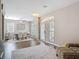 Open concept dining room features wood floors, wainscoting, large windows, and updated lighting at 2256 Pantucket Dr, Wesley Chapel, FL 33543