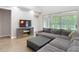 Cozy living room with a plush sectional, sliding doors to lanai, and a media console at 2256 Pantucket Dr, Wesley Chapel, FL 33543