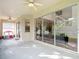 Covered patio with ceiling fans and a view into the living room and kitchen at 2256 Pantucket Dr, Wesley Chapel, FL 33543