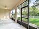Relaxing screened porch boasts a ceiling fan and views of the manicured backyard at 2256 Pantucket Dr, Wesley Chapel, FL 33543