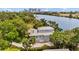 Stunning aerial view of the home and its riverfront location near the city, surrounded by lush trees at 2314 N Riverside Dr, Tampa, FL 33602