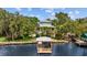 Aerial view of the property, revealing a charming waterfront home with a private boathouse and dock at 2314 N Riverside Dr, Tampa, FL 33602