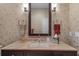Bathroom vanity featuring a granite countertop, dark wood cabinetry and decorative wallpaper at 2314 N Riverside Dr, Tampa, FL 33602