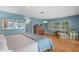 Light-filled bedroom features hardwood floors, a dresser and lounge chair at 2314 N Riverside Dr, Tampa, FL 33602