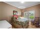Cozy bedroom with hardwood floors, large windows, and a rocking chair, creating a relaxing retreat at 2314 N Riverside Dr, Tampa, FL 33602