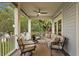 Relax in this covered porch featuring comfortable seating, ceiling fan, and a lovely view of the green surroundings at 2314 N Riverside Dr, Tampa, FL 33602
