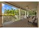 This covered porch offers comfortable seating, ceiling fans, and a peaceful view of the surrounding greenery at 2314 N Riverside Dr, Tampa, FL 33602