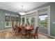 Dining room with woven chairs, wood floors, and views to the outdoor patio at 2314 N Riverside Dr, Tampa, FL 33602