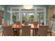 Dining room with wood table and woven chairs with views to a tropical backyard at 2314 N Riverside Dr, Tampa, FL 33602