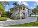 Charming two-story home with a porch, a paved driveway, and beautiful waterfront access at 2314 N Riverside Dr, Tampa, FL 33602