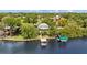 Waterfront home featuring a private dock and lush landscaping at 2314 N Riverside Dr, Tampa, FL 33602