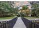 Charming home exterior view from the dock featuring lush tropical landscaping and beautiful architectural details at 2314 N Riverside Dr, Tampa, FL 33602
