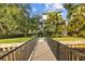 Charming home exterior view from the dock featuring lush tropical landscaping and beautiful architectural details at 2314 N Riverside Dr, Tampa, FL 33602
