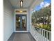 Inviting front door with a covered porch, offering a glimpse of the serene and lush outdoor scenery at 2314 N Riverside Dr, Tampa, FL 33602