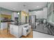 Eat-in kitchen with stainless appliances, granite countertops, and pendant lights at 2314 N Riverside Dr, Tampa, FL 33602