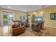 Living room featuring leather furniture, hardwood floors, and water views at 2314 N Riverside Dr, Tampa, FL 33602