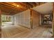 Covered space under the home providing a shaded area with wood decking, lattice, and a small storage room at 2314 N Riverside Dr, Tampa, FL 33602