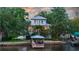 Stunning waterfront home with a boat dock, lush landscaping, and architectural details at 2314 N Riverside Dr, Tampa, FL 33602