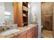 Modern bathroom featuring a double vanity with granite countertops and tiled walk-in shower at 2421 Brevard Ne Rd, St Petersburg, FL 33704