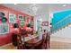 Bright dining room exhibiting a colorful accent wall, wood table, and chandelier at 2421 Brevard Ne Rd, St Petersburg, FL 33704