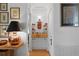 Hallway featuring built-in shelving, hardwood floors, and unique accent pieces at 2421 Brevard Ne Rd, St Petersburg, FL 33704