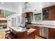 Kitchen displaying stainless appliances, wood cabinets, and granite countertops at 2421 Brevard Ne Rd, St Petersburg, FL 33704