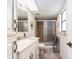 Bathroom featuring a shower with glass door, updated vanity and fixtures, plus a window at 2555 Royal Pines Cir # A, Clearwater, FL 33763