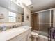 Bright bathroom featuring a shower with glass door, updated vanity and fixtures, plus a large mirror at 2555 Royal Pines Cir # A, Clearwater, FL 33763