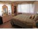 Comfortable bedroom with natural light, cream-colored decor, and matching wicker furniture at 2555 Royal Pines Cir # A, Clearwater, FL 33763