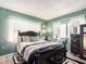 Comfortable bedroom with wood laminate flooring, two windows, and black accents at 2555 Royal Pines Cir # A, Clearwater, FL 33763