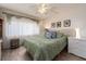 Cozy bedroom with neutral walls, hardwood floors, and a comfortable bed with decorative pillows at 2555 Royal Pines Cir # A, Clearwater, FL 33763