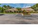 Exterior of building with landscaping, parking spaces and trees at 2555 Royal Pines Cir # A, Clearwater, FL 33763