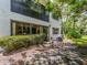 Charming home exterior with lush landscaping, visible air conditioning units, and natural light at 2555 Royal Pines Cir # A, Clearwater, FL 33763