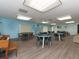 Game room with tables, chairs and an abundance of light at 2555 Royal Pines Cir # A, Clearwater, FL 33763