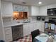 Bright eat-in kitchen featuring stainless steel appliances, white cabinets, and marble countertops at 2555 Royal Pines Cir # A, Clearwater, FL 33763