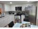 Modern eat-in kitchen with white cabinets, stainless steel appliances, and a cozy breakfast nook at 2555 Royal Pines Cir # A, Clearwater, FL 33763