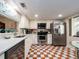 Well lit kitchen featuring stainless steel appliances, marble countertops, and patterned flooring at 2555 Royal Pines Cir # A, Clearwater, FL 33763
