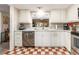 Bright kitchen featuring white cabinets, marble countertops, stainless steel appliances and patterned flooring at 2555 Royal Pines Cir # A, Clearwater, FL 33763