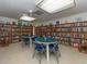 Library with bookshelves, tables, chairs and an abundance of light at 2555 Royal Pines Cir # A, Clearwater, FL 33763