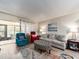 Bright living room with hardwood floors, comfortable seating, natural light, and access to the outdoors at 2555 Royal Pines Cir # A, Clearwater, FL 33763