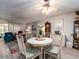 Open living room featuring a round dining table, ceiling fan, and seating area with natural light at 2555 Royal Pines Cir # A, Clearwater, FL 33763