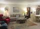 Inviting living room featuring wood floors, neutral-toned furniture, a large rug, and a dining area at 2555 Royal Pines Cir # A, Clearwater, FL 33763