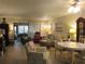 Bright living room featuring lots of seating, a sliding door to the outside, and dining area at 2555 Royal Pines Cir # A, Clearwater, FL 33763