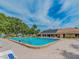 Community pool with many seats and a view of the Clubhouse at 2555 Royal Pines Cir # A, Clearwater, FL 33763
