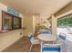 Inviting poolside patio with ample seating, ceiling fan, and serving window for refreshments and shade at 2555 Royal Pines Cir # A, Clearwater, FL 33763
