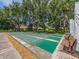 Outdoor shuffleboard court with shade trees and park benches, perfect for relaxing recreational activities at 2555 Royal Pines Cir # A, Clearwater, FL 33763
