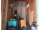 Storage room with shelving containing various items including water filter, bins, luggage, and tires at 2555 Royal Pines Cir # A, Clearwater, FL 33763