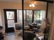Enclosed sunroom featuring comfortable seating and a glass-top dining table with views of the outdoors at 2555 Royal Pines Cir # A, Clearwater, FL 33763